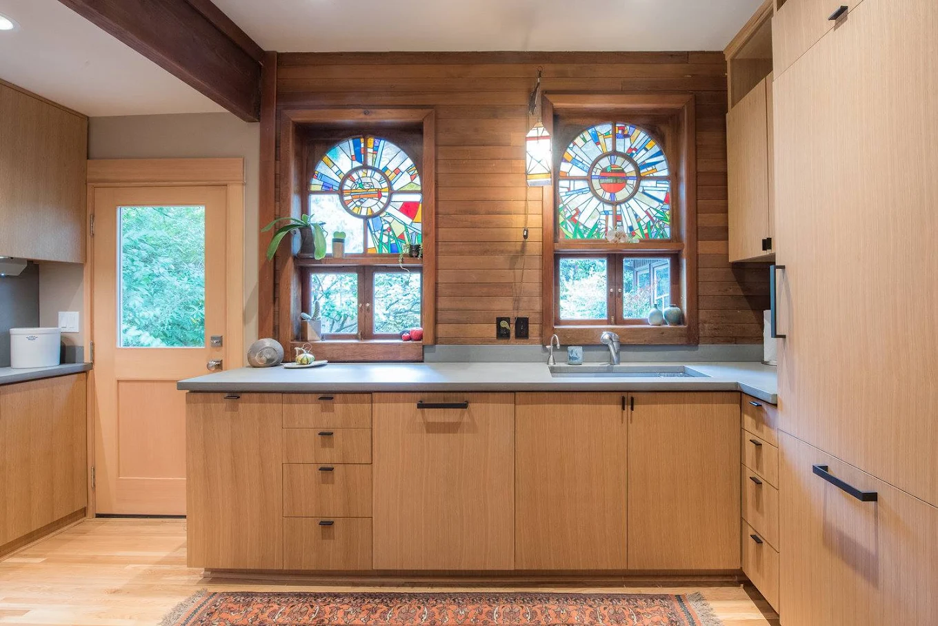 Wood-paneled Craftsman kitchen with stained glass
