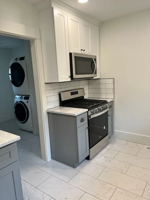 White kitchen with stacked laundry