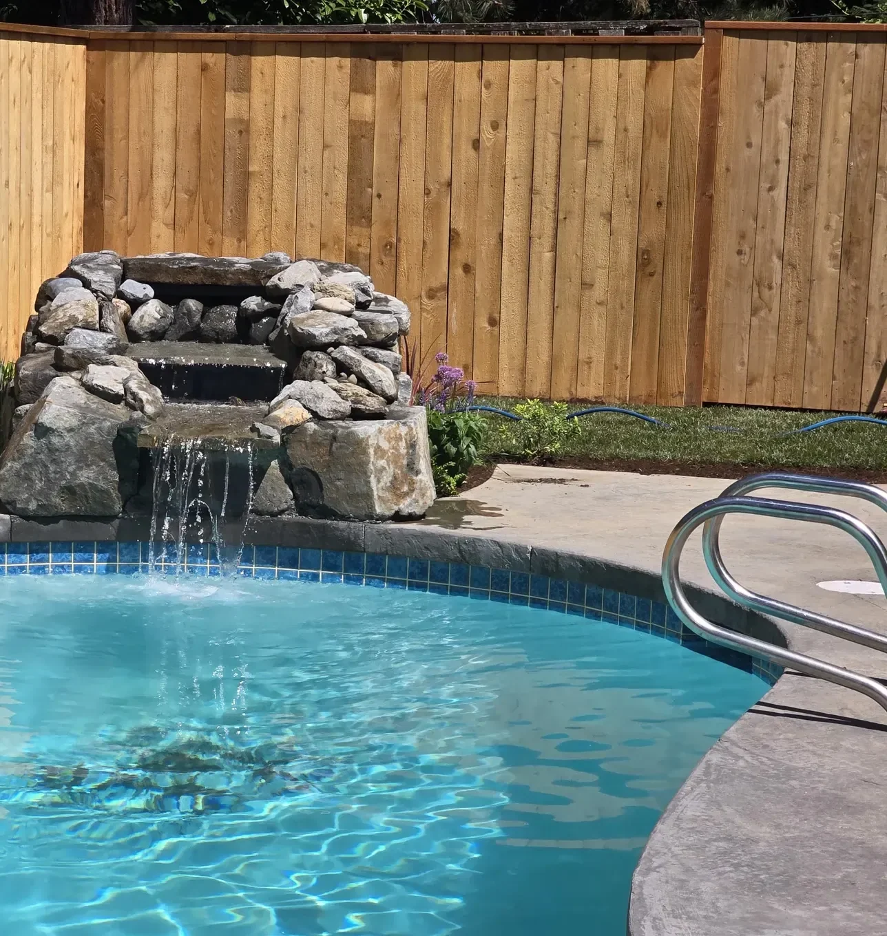 Rock waterfall feeding the renovated pool