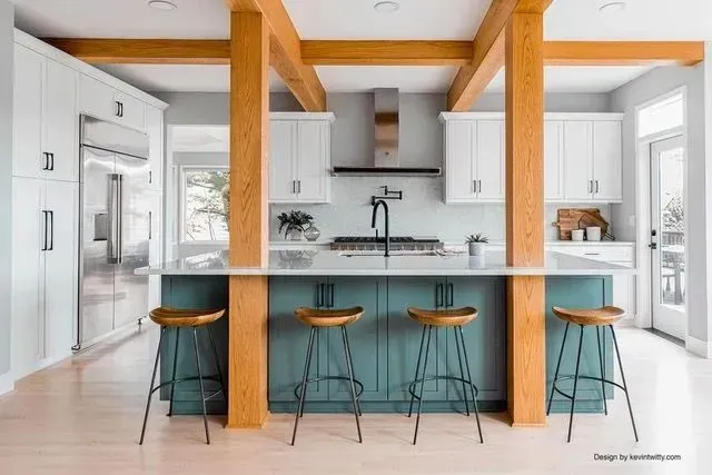 Bethany kitchen wide view with teal blue island, bar seating, exposed wood beams