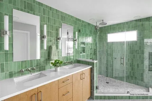 Bethany primary bath with green stacked tile, double wood vanity, walk-in shower