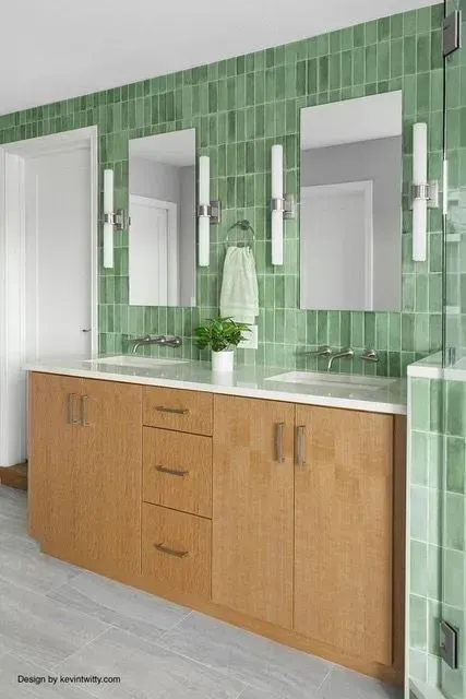 Primary bath double-sink vanity in front of green stacked-tile wall