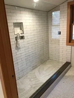 White subway-tile shower with curbless entry