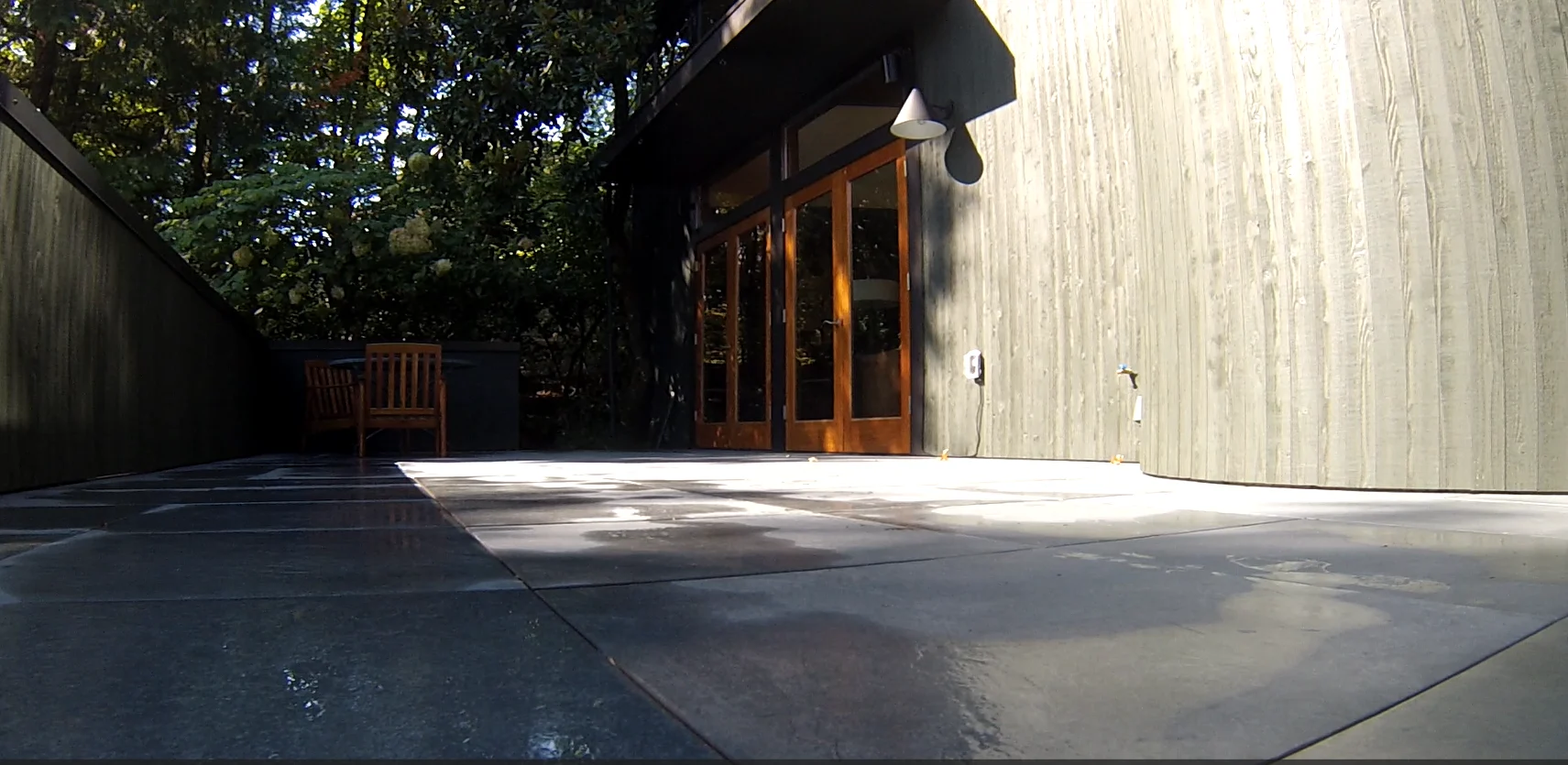 Porcelain pavers on pedestals and new cedar siding stained Jasper