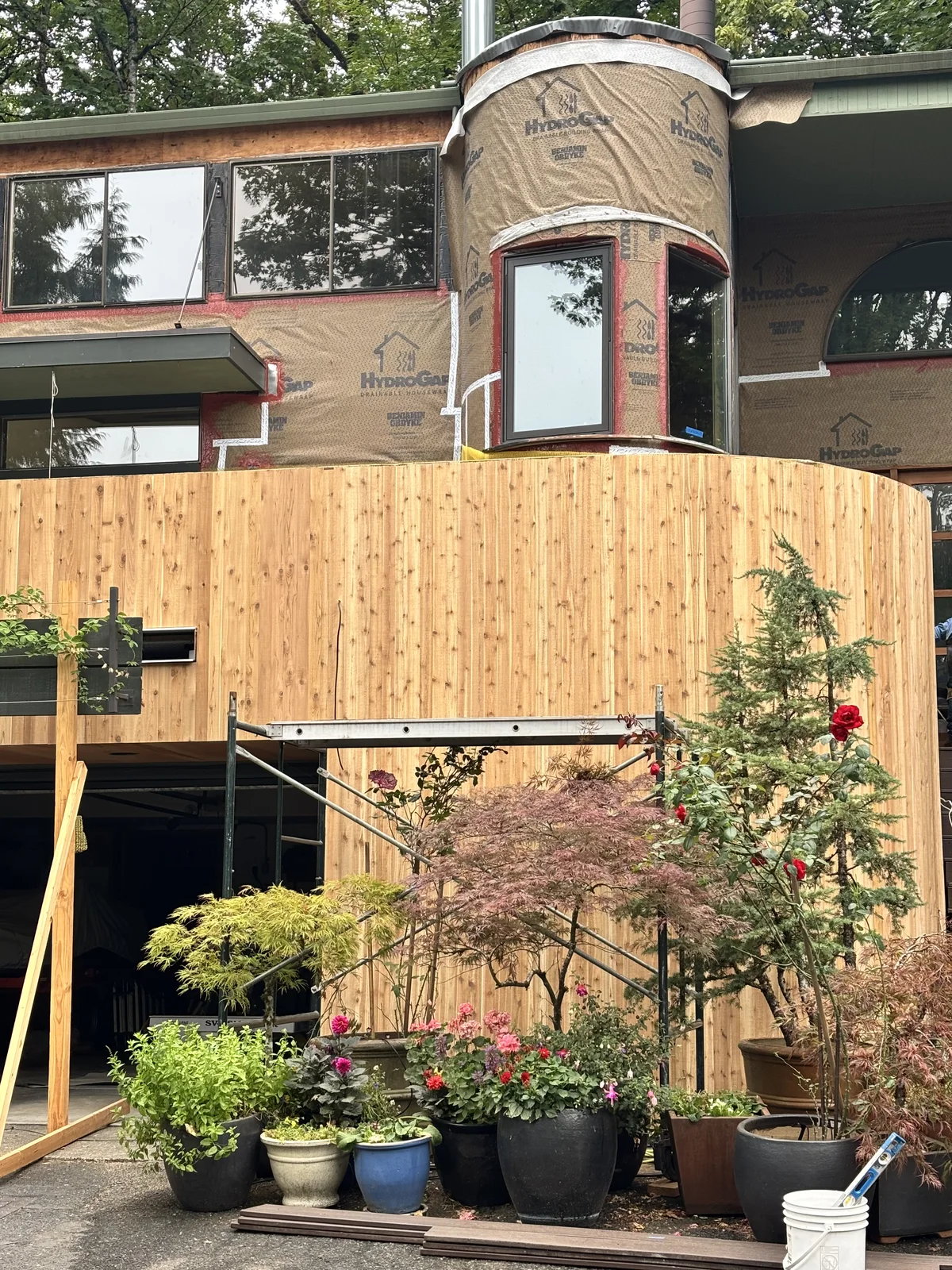 New cedar siding going up over the house wrap