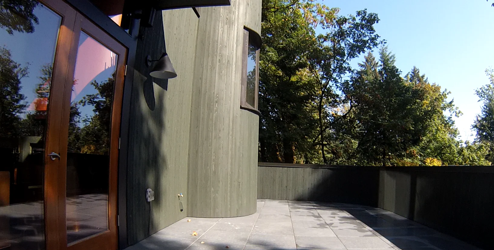 The finished patio with pavers, the doors, and the siding stained Jasper